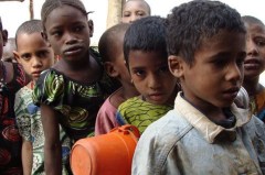 During the Sahel drought of 2012 children at the Tin-Ediar school in Burkina Faso line up for meals provided by the World Food Programme. The children are provided breakfast and lunch at school. (WFP/Anne Poulsen)